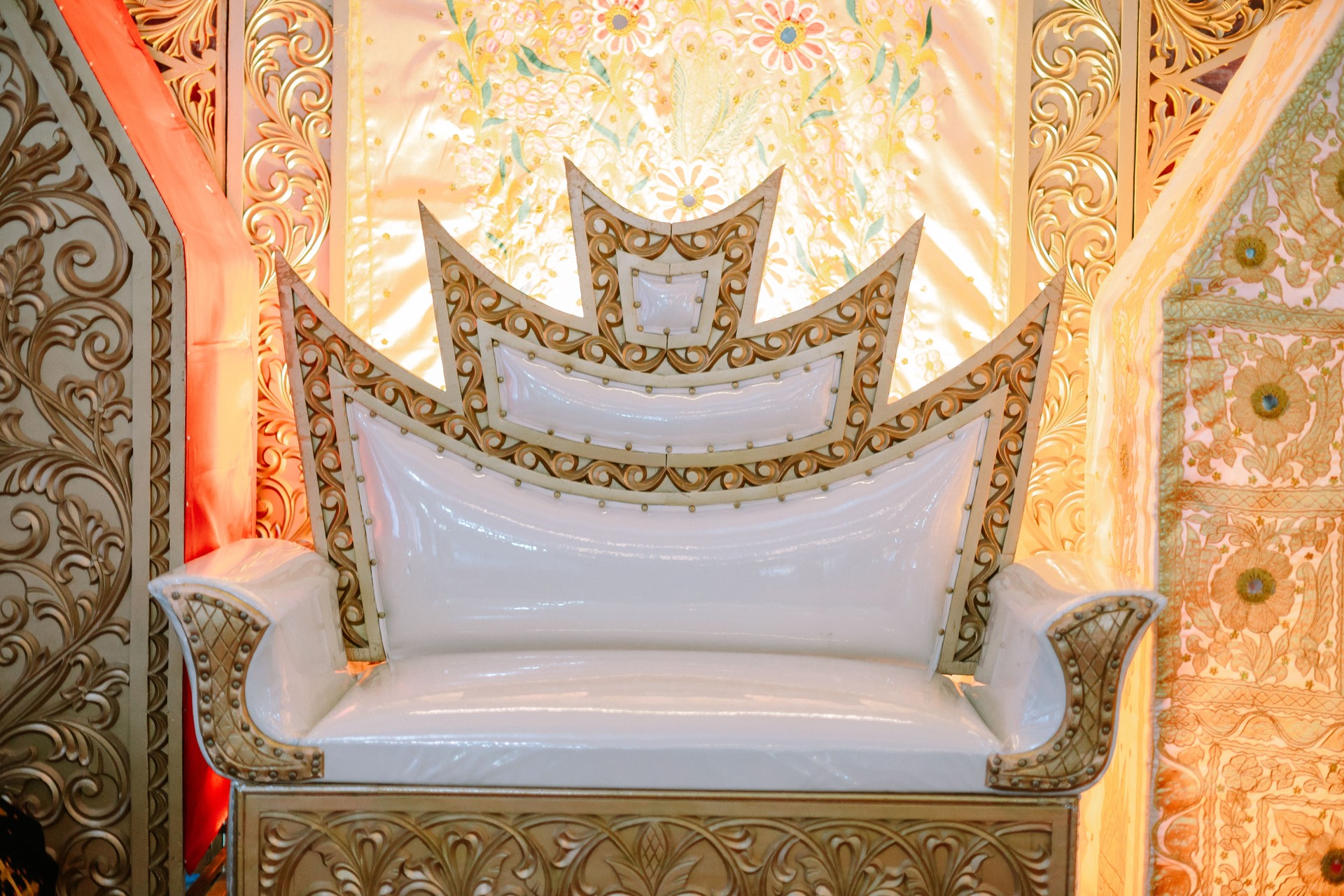 Ornate throne with golden accents for a regal celebration backdrop